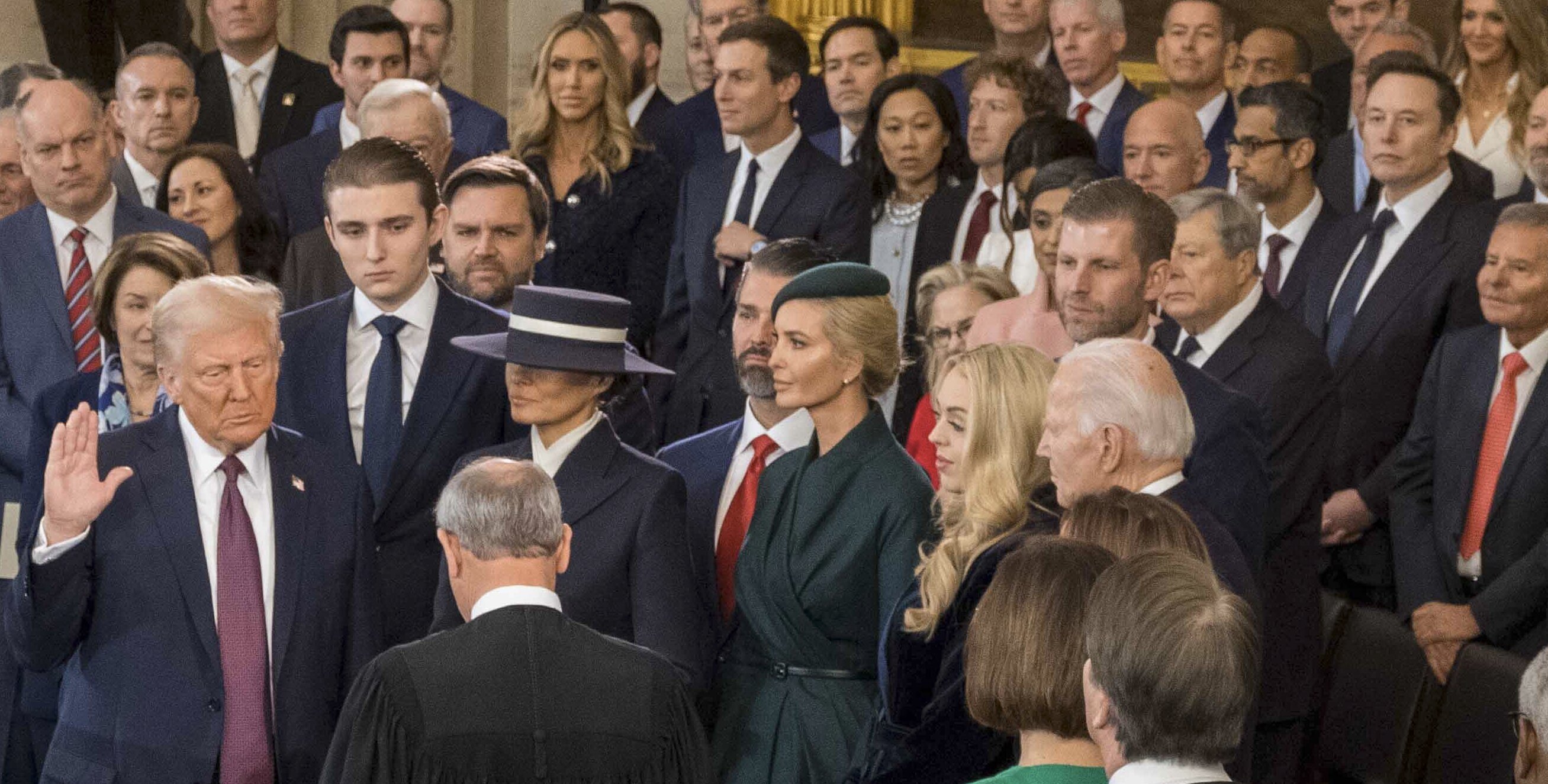 Photo showing Meta's Mark Zuckerberg, Amazon's Jeff Bezos, Google's Pichai Sundararajan, and Elon Musk standing almost immediately behind Donald Trump during his second inauguration